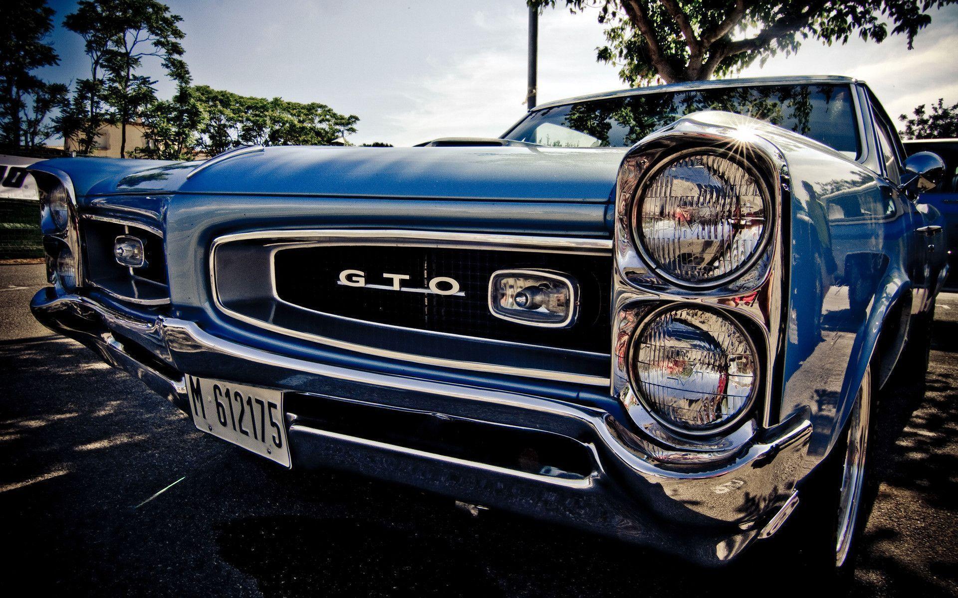 Pontiac GTO headlights shining from the sun